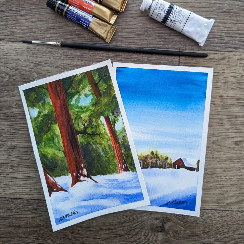 Two watercolor paintings. One is of for a tree in a snowy forest. The second one is cabin set in a snowy field with trees in the background