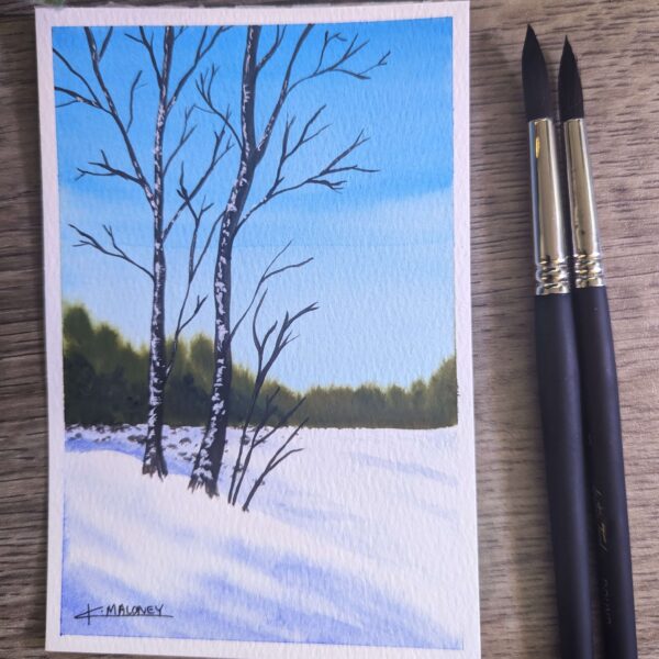 Watercolor painting of two trees on a snow hill, with a light blue sky in the background and bushes off in the distance.