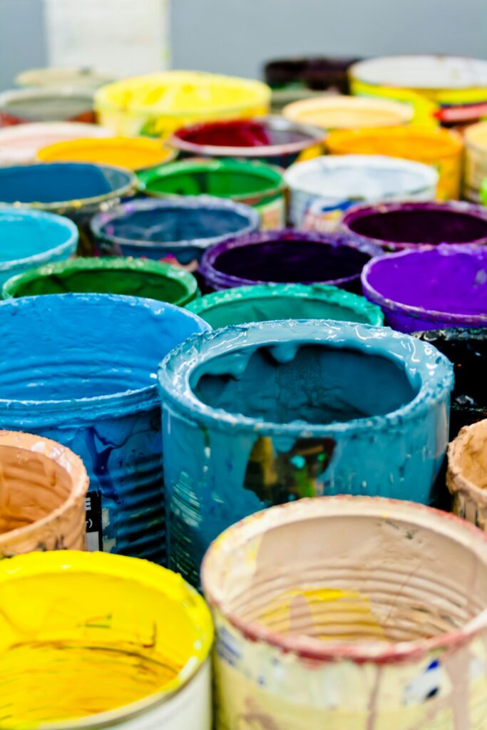 Stock photo of paint cans with varies bright colors of paint. Bright colors are the key to helping break creative block.