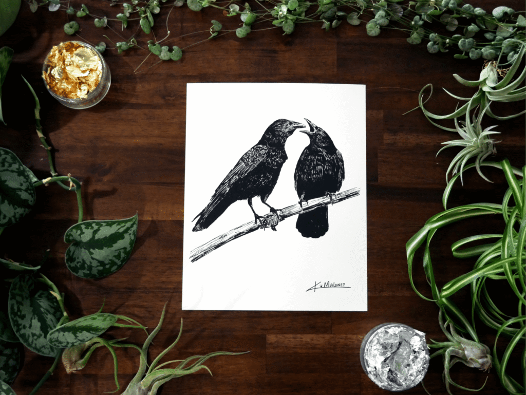 The Crow Family art print is an 8x10 black and white image two crows. The one on the left is looking at the one on the right which has it's mouth open like it has something to say. The art print is surrounded by green plants, with some gold and silver leaf in two of the corners.