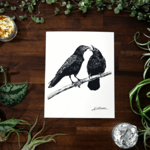 The Crow Family art print is an 8x10 black and white image two crows. The one on the left is looking at the one on the right which has it's mouth open like it has something to say. The art print is surrounded by green plants, with some gold and silver leaf in two of the corners.