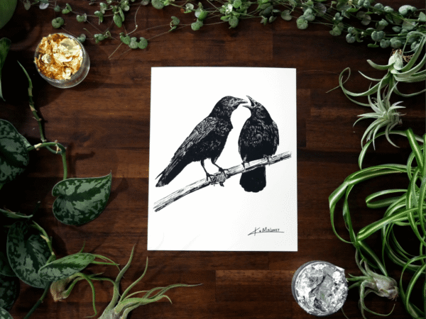 The Crow Family art print is an 8x10 black and white image two crows. The one on the left is looking at the one on the right which has it's mouth open like it has something to say. The art print is surrounded by green plants, with some gold and silver leaf in two of the corners.