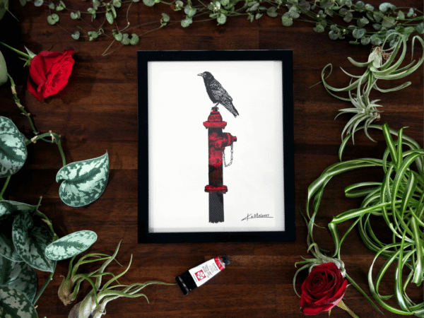 8x10 art print of a crow sitting on a hydrate, the print is surrounded by Green plants as a flay lay frame and mixed into the plants are two red roses and a tube of red paint. This photo has the print inside of a black 8x10 frame.