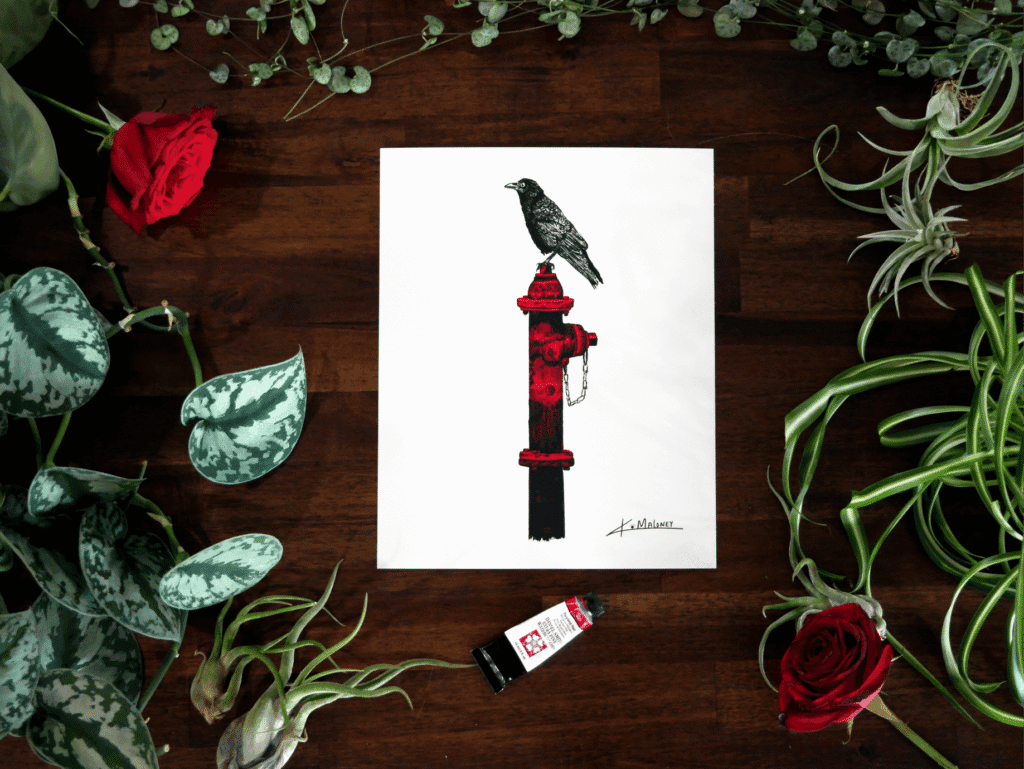 8x10 art print of a crow sitting on a hydrate, the print is surrounded by Green plants as a flay lay frame and mixed into the plants are two red roses and a tube of red paint.